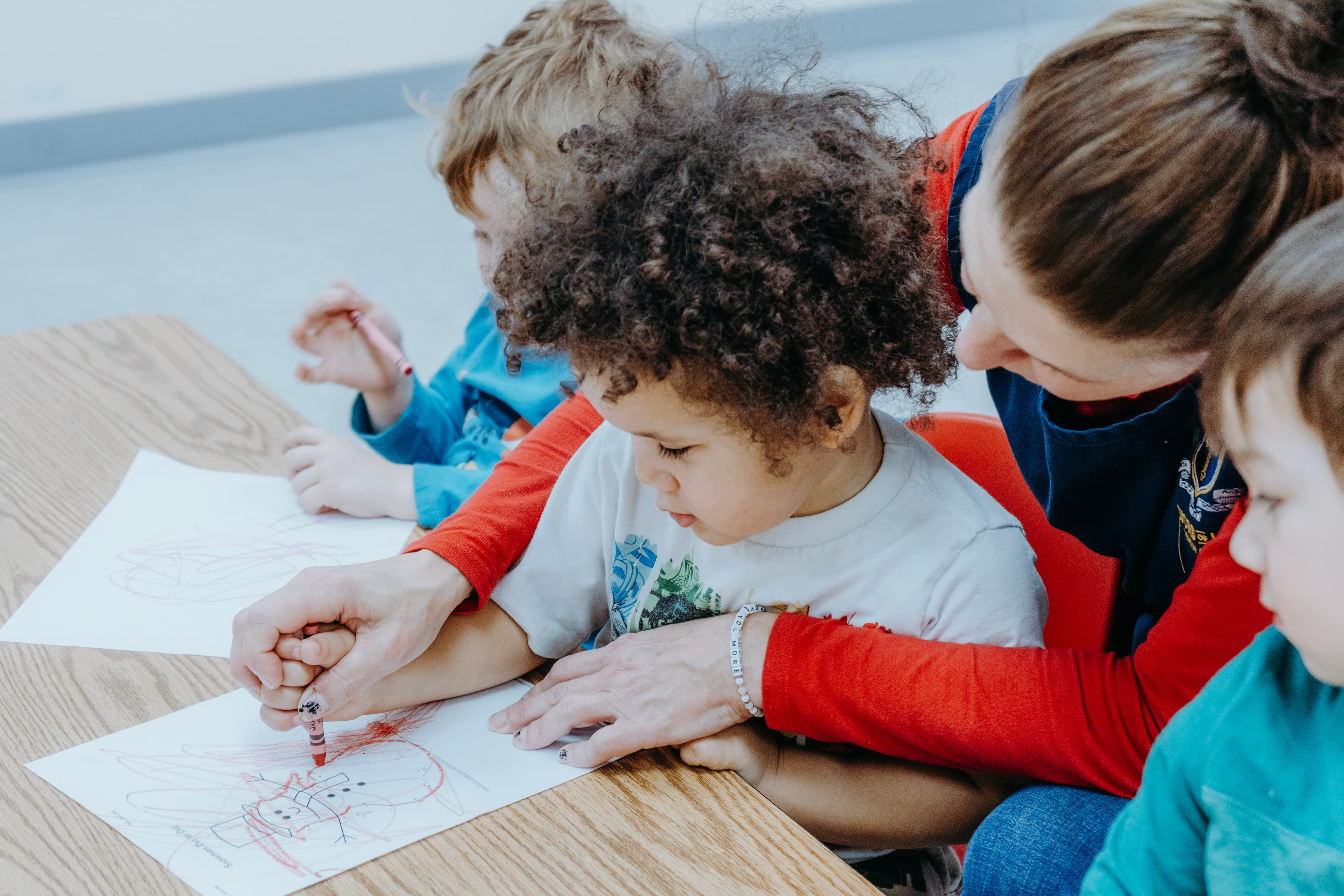 Teacher working closely with a student in a small classroom setting