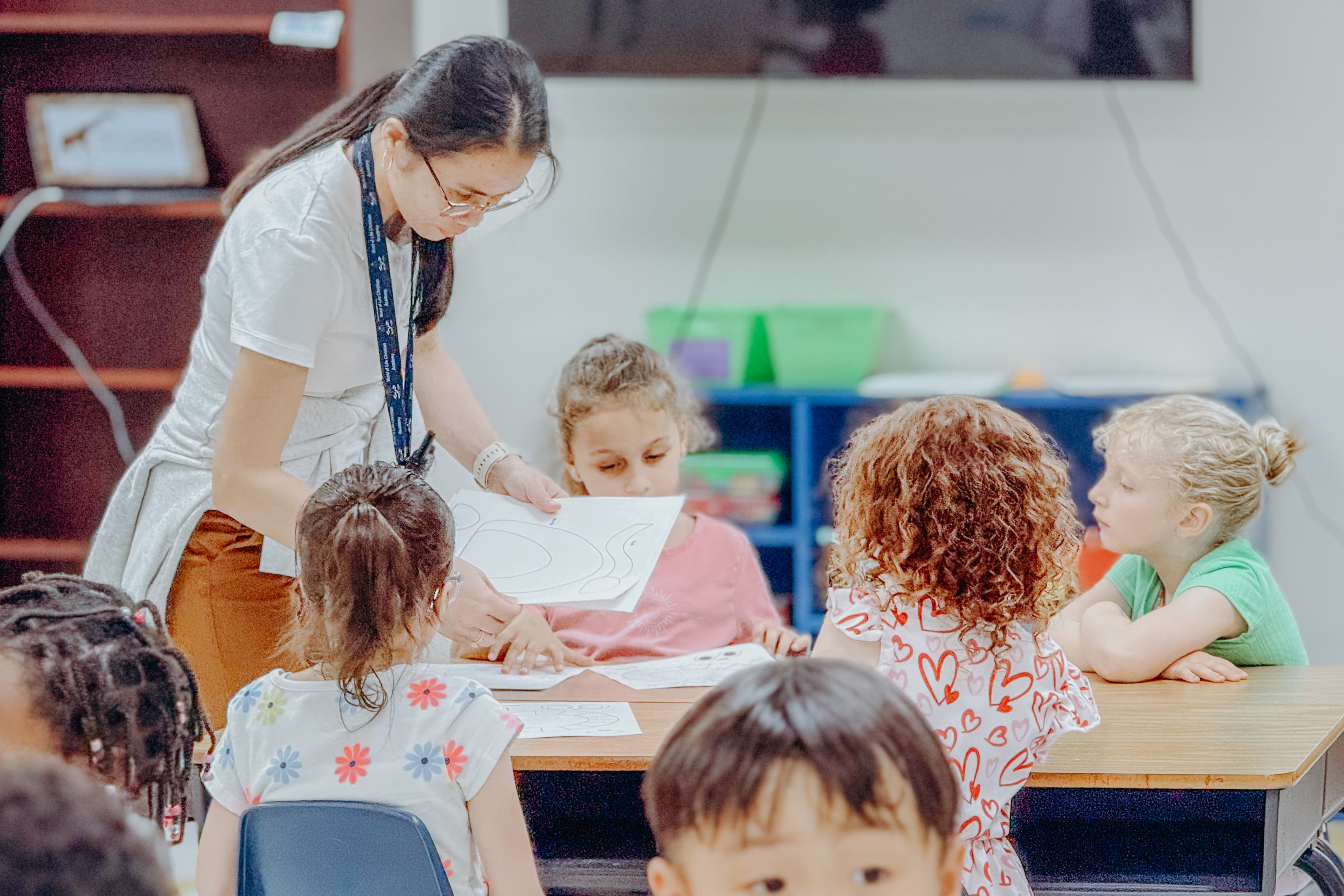 Diverse elementary students with a caring teacher in a Christian academy classroom