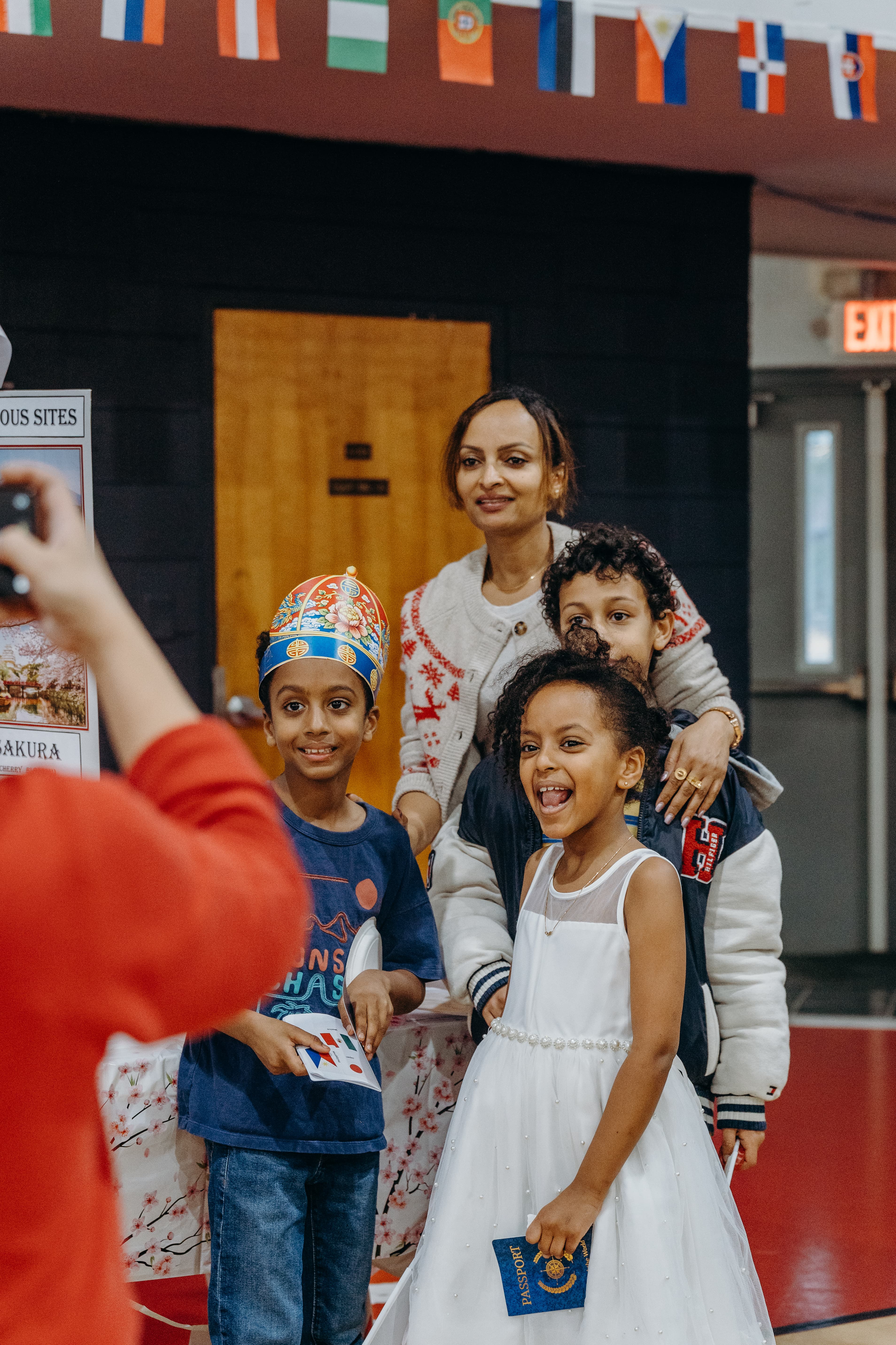 School hallway with teachers greeting children, safe and welcoming environment