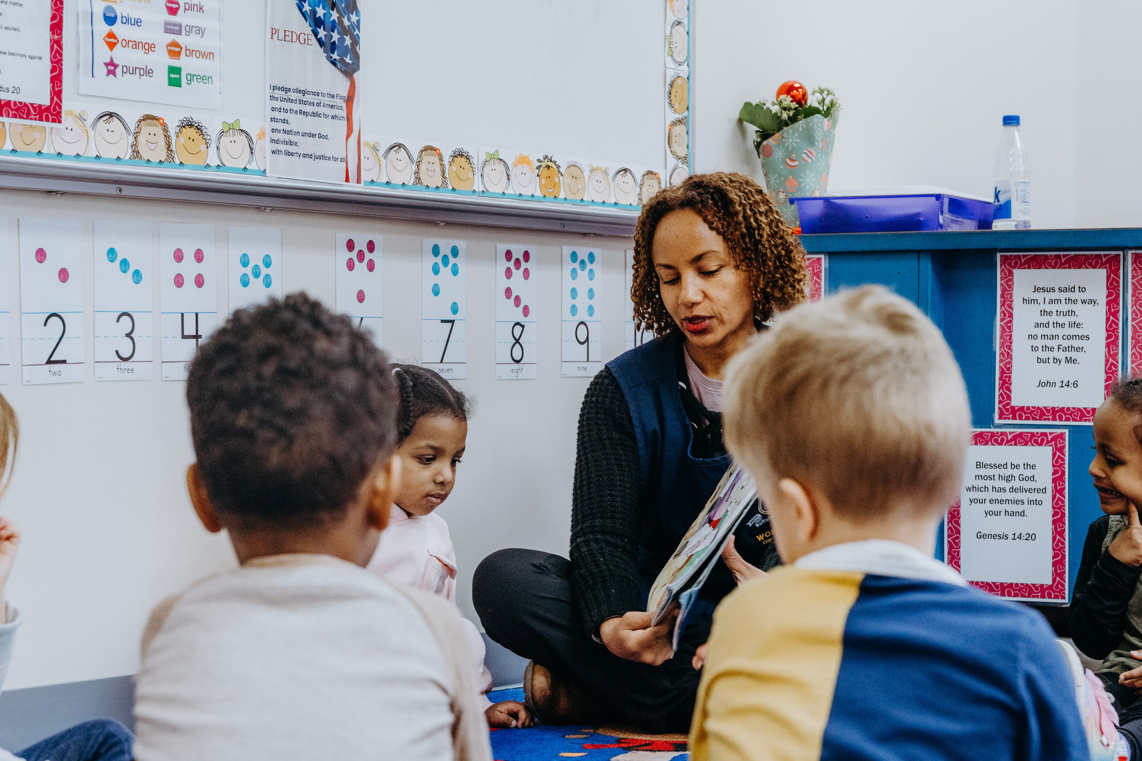 Teacher guiding a student in a small class setting